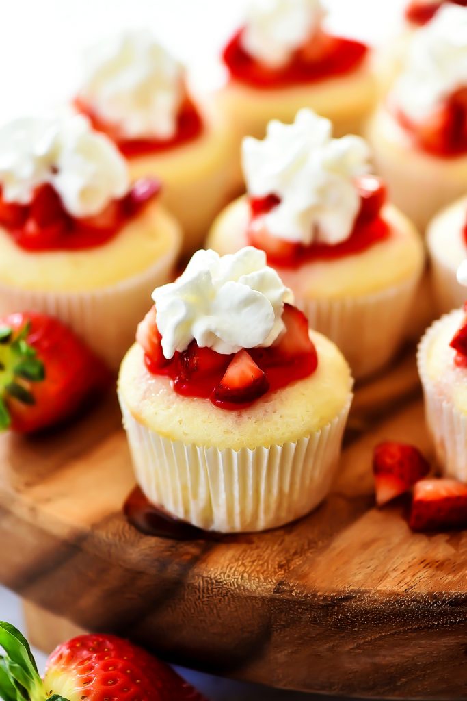 Strawberry Shortcake Cupcakes are white cakes that are light as air and topped with strawberries, glaze and whipped cream. Life-in-the-Lofthouse.com