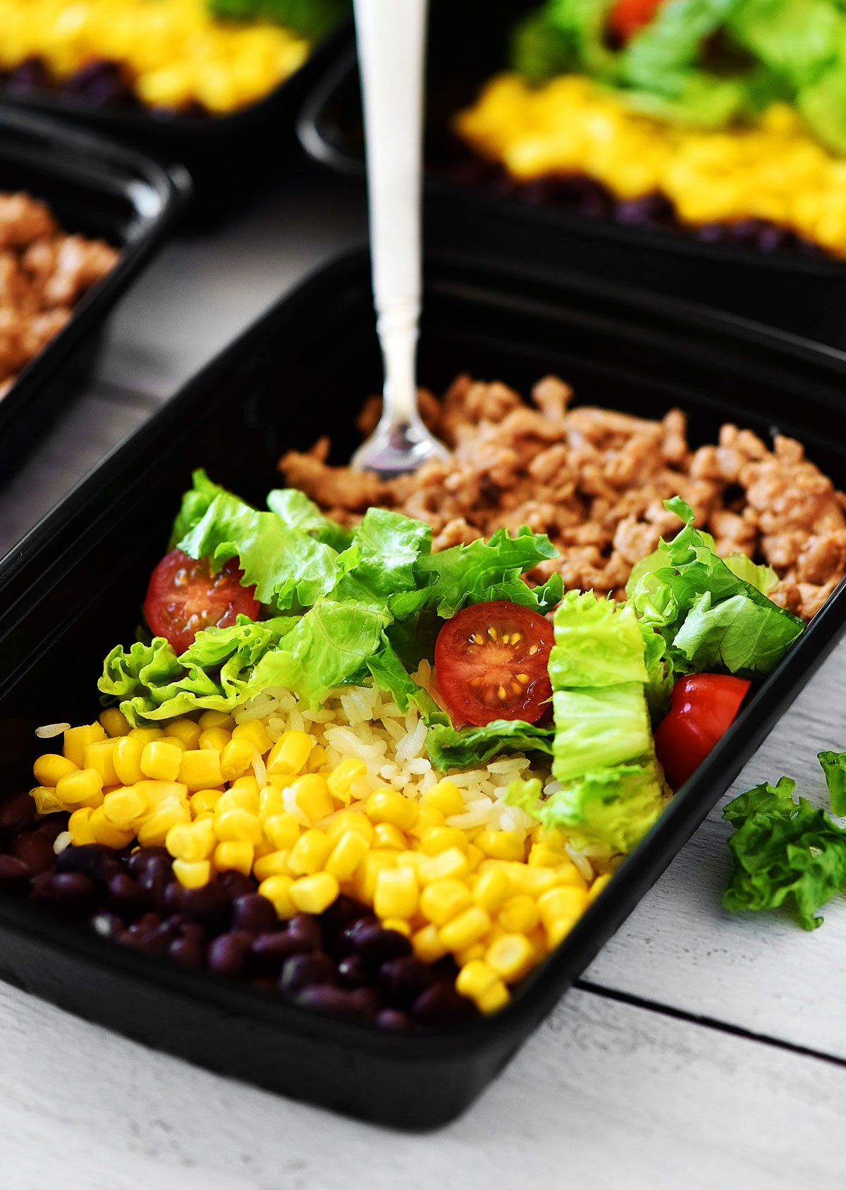 Taco Salad Meal Prep Bowls are filled with seasoned ground turkey, rice, beans, corn and lettuce. Life-in-the-Lofthouse.com