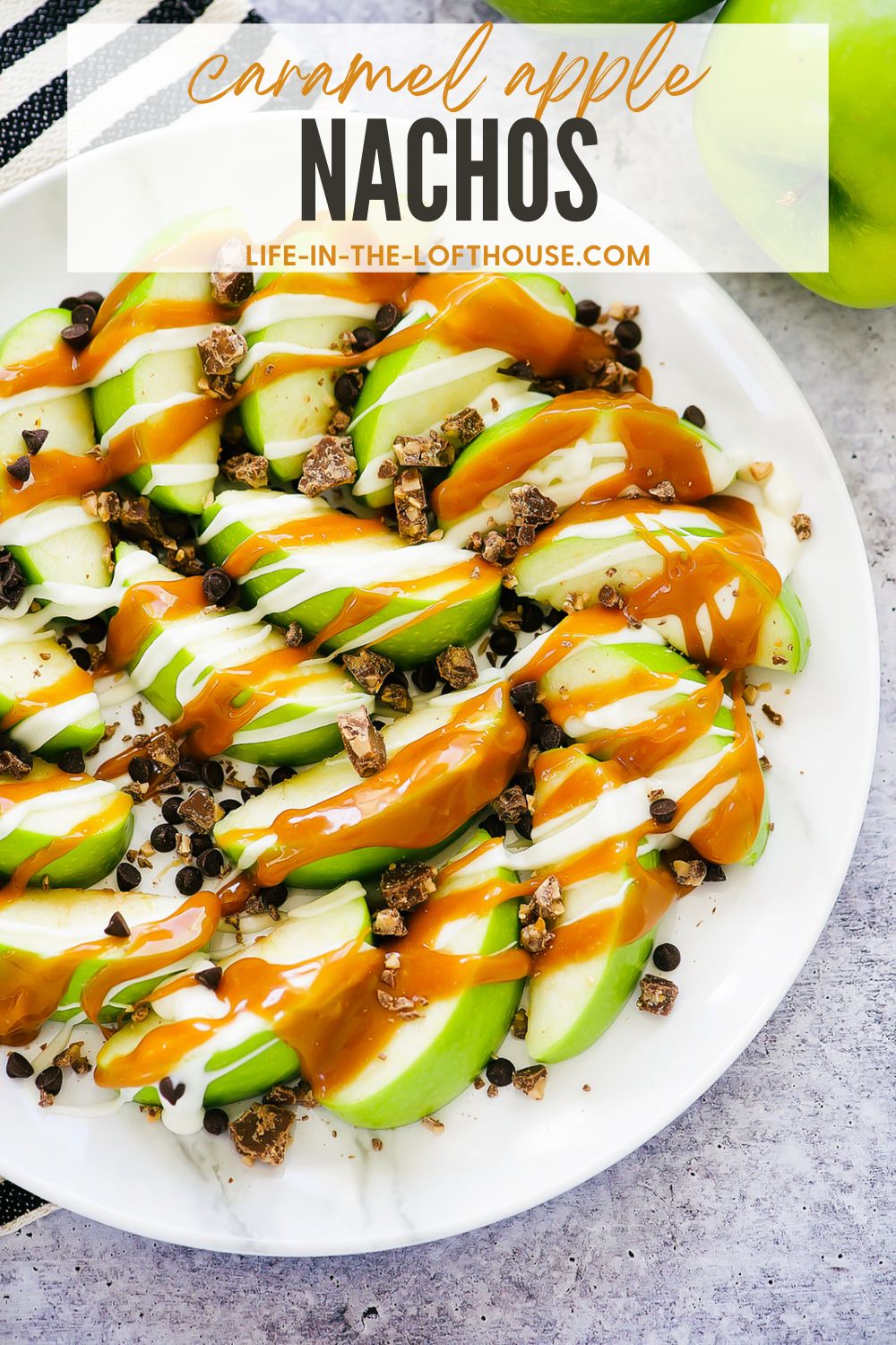 Caramel Apple Nachos start with slices of green apples then covered in warm caramel sauce, white chocolate and crushed candy bars. Life-in-the-Lofthouse.com