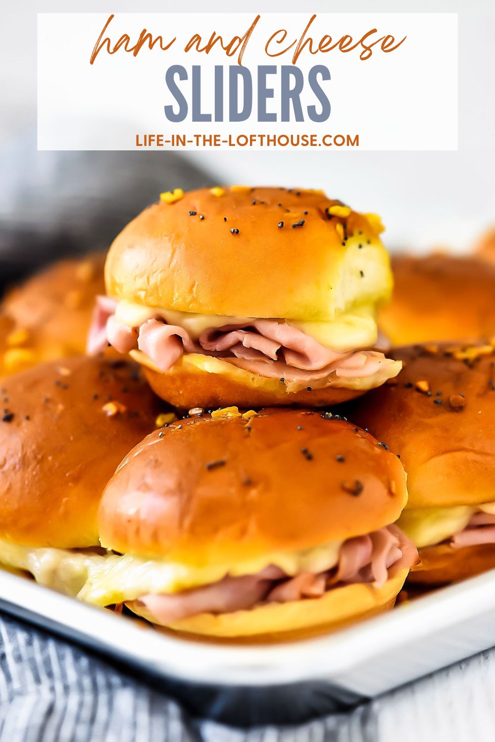 Ham and Cheese Sliders are savory and delicious baked ham sandwiches with a mustard poppy seed dressing. Life-in-the-Lofthouse.com