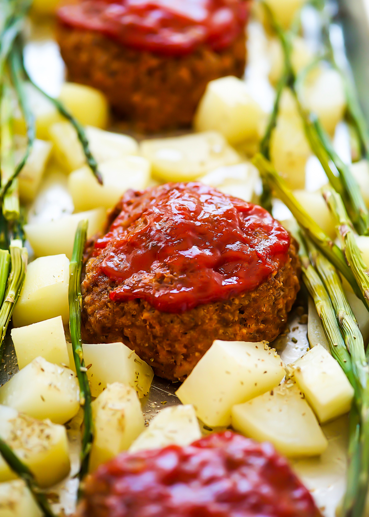 Sheet Pan Meatloaf dinner is individual mini meatloaves, asparagus, and potatoes all cooked to perfection on one pan.