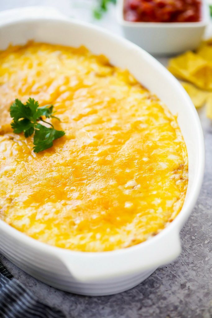 Warm Bean Dip is creamy refried beans mixed with sour cream and Mexican seasonings and melted cheese. Life-in-the-Lofthouse.com