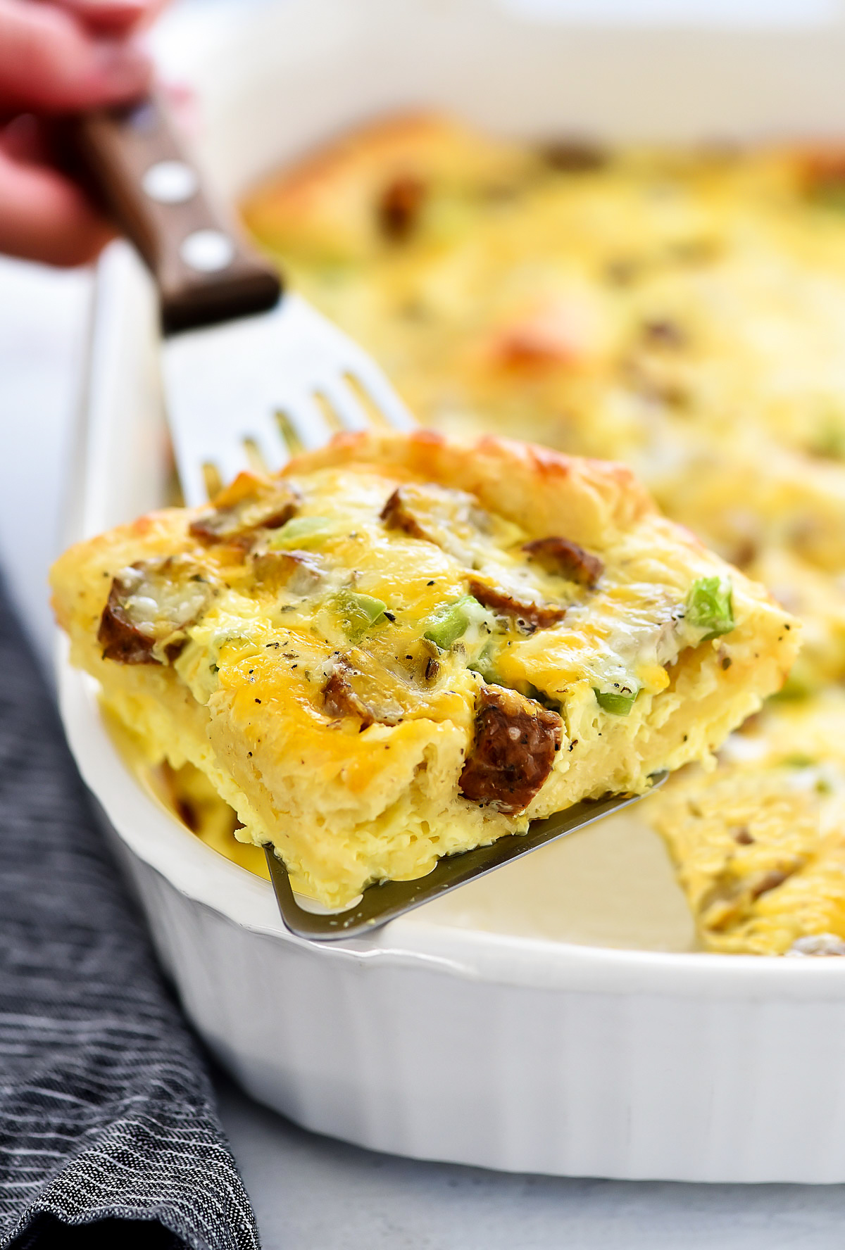 Breakfast Bake is filled with a delicious egg mixture, sausage and green bell peppers over a crescent crust. Life-in-the-Lofthouse.com