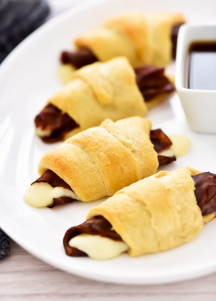 French Dip Crescents are savory little beef sandwiches filled with roast beef and cheese inside golden crescent rolls.