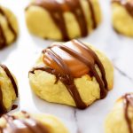 Twix Cookies start with a buttery thumbprint cookie topped with caramel and milk chocolate. Life-in-the-Lofthouse.com