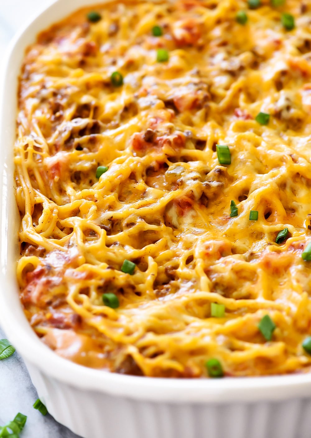 Taco Spaghetti is filled with ground beef, tomatoes, green chilies, taco seasonings and cheese with spaghetti noodles.