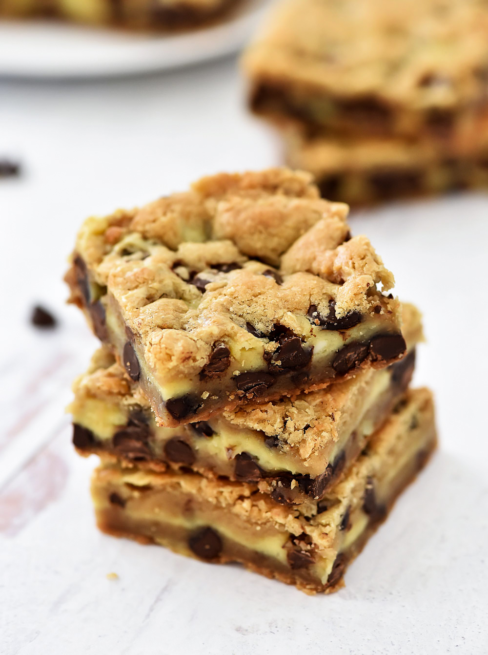 Layers of chocolate chip cookie and cheesecake are what is inside these Cheesecake Chocolate Chip Cookie Bars.