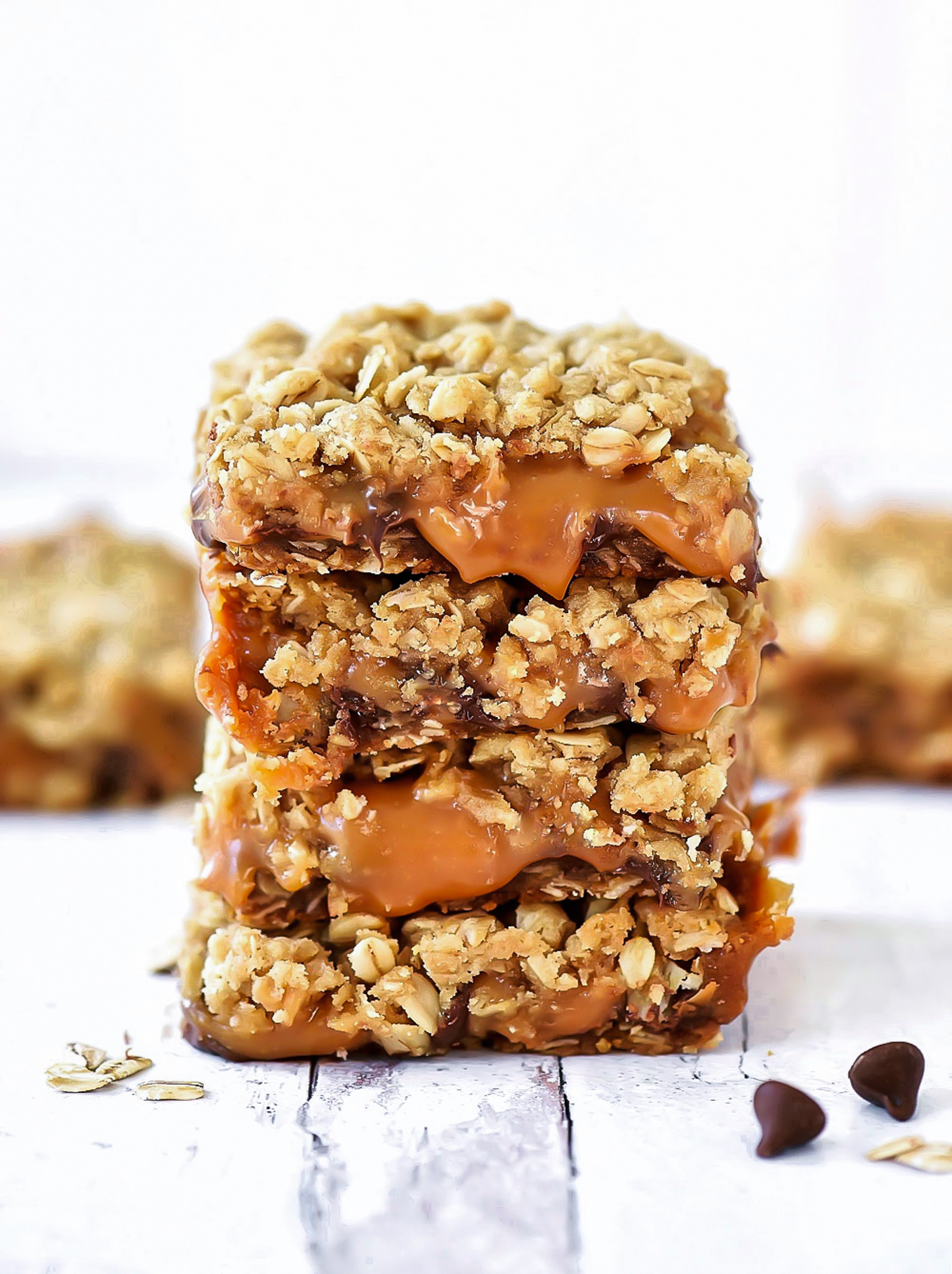 Oatmeal Carmelitas are layered cookie bars with an oatmeal and brown sugar crust and gooey caramel and chocolate filling!