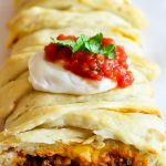 Taco Braid is filled with seasoned ground beef, beans and cheese wrapped up in pizza dough then baked.