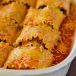 Beef enchilada lasagna roll ups are made up of Beef, enchilada sauce and taco seasoning wrapped up in lasagna noodles and covered in gooey cheese. Life-in-the-Lofthouse.com
