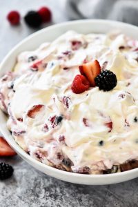 Sliced strawberries, blueberries, blackberries and raspberries covered in a sweet cream cheese fluff. Life-in-the-Lofthouse.com