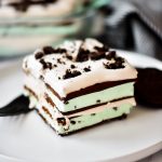 Layers of mint chocolate ice cream sandwiches, Cool Whip, and crushed Oreo cookie create one incredible dessert.