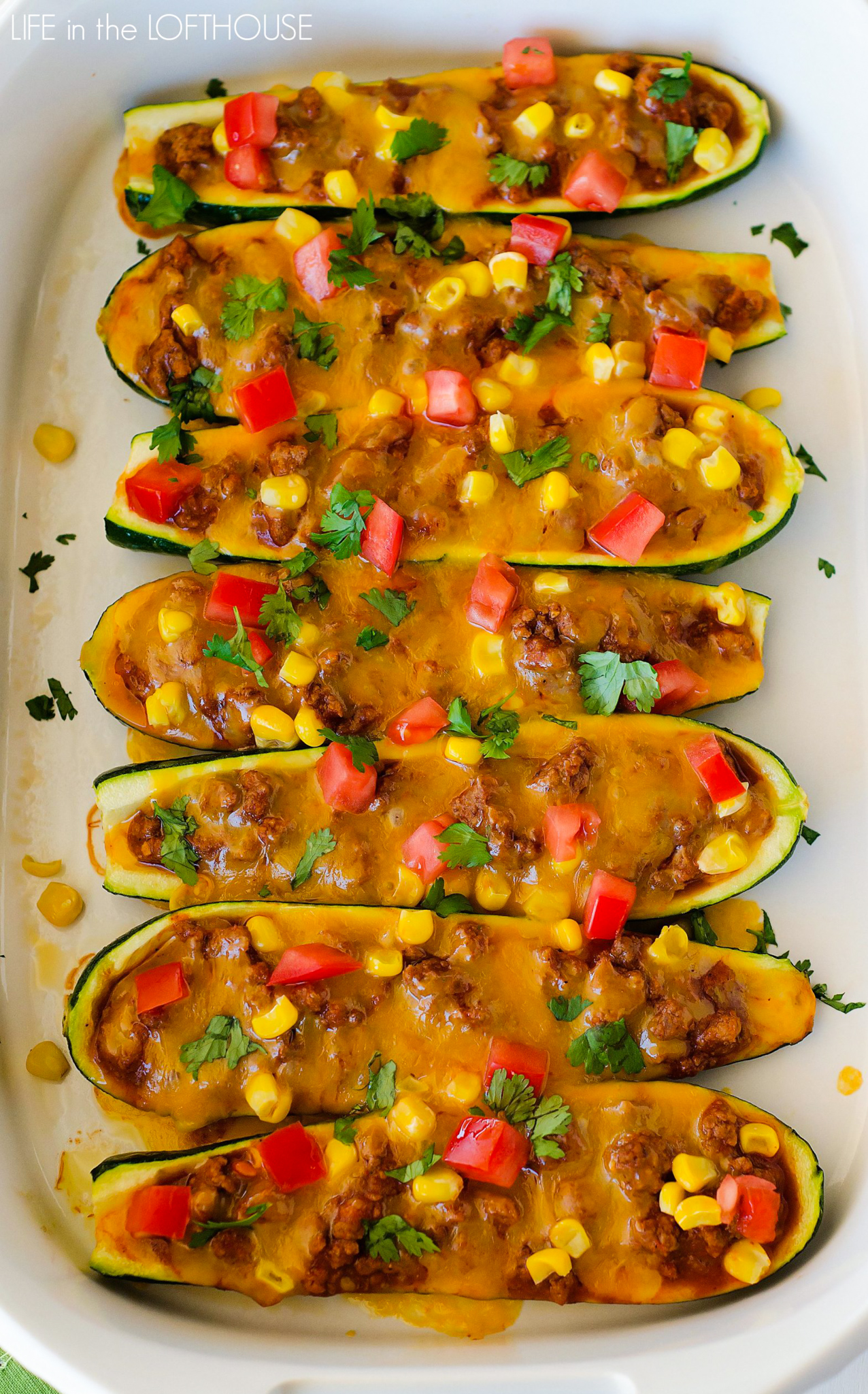 Beef enchilada zucchini boats are full of seasoned ground beef, homemade enchilada sauce and a couple veggies that are stuffed on top of zucchini. Life-in-the-Lofthouse.com