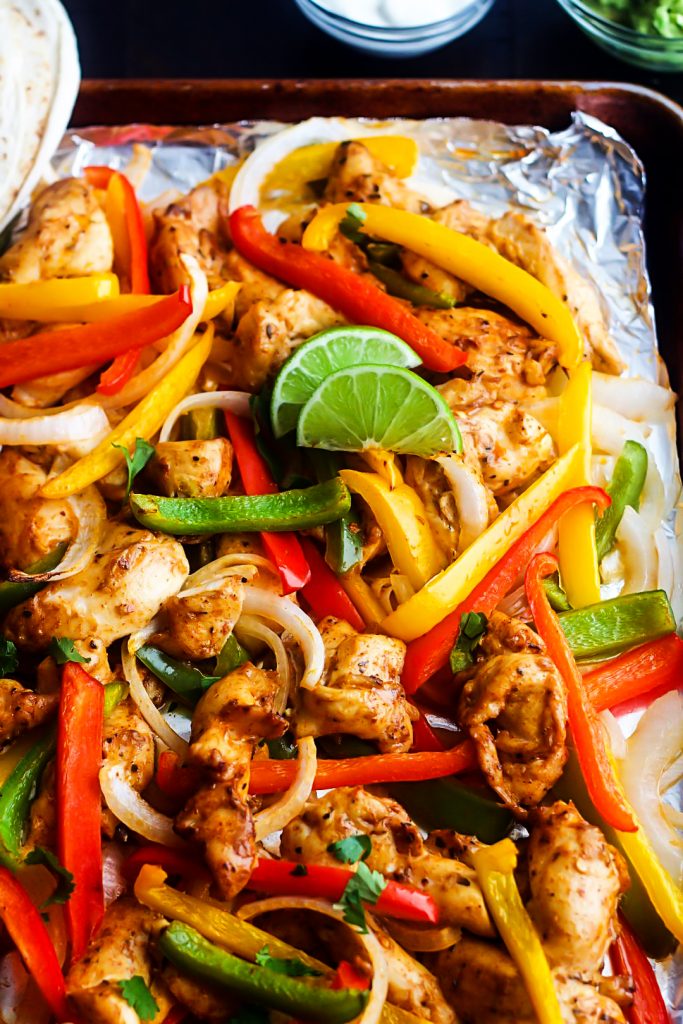 Sheet Pan Chicken Fajitas are pieces of chicken, peppers and onions full of southwest flavor. Life-in-the-Lofthouse.com