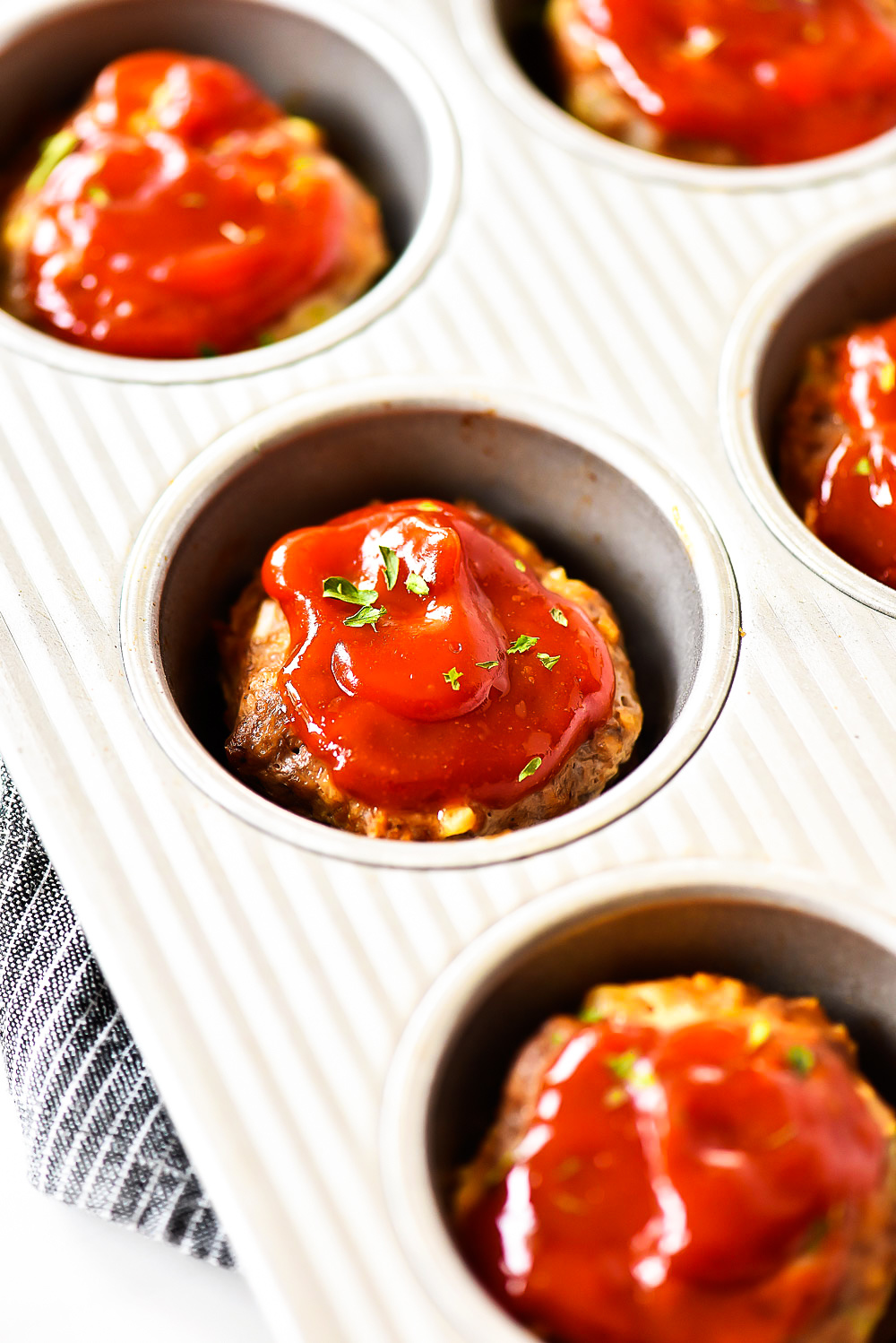 Mini Meatloaf Cups made with ground beef, cottage cheese, breadcrumbs and more. Topped with ketchup.