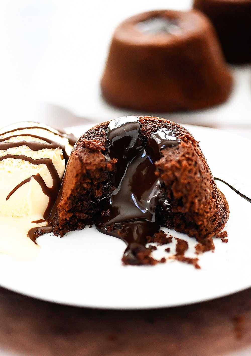 Easy Chocolate Lava Cakes are mini cakes with a warm center of hot fudge, topped with a big scoop of vanilla ice cream and then drenched in magic shell. Life-in-the-Lofthouse.com