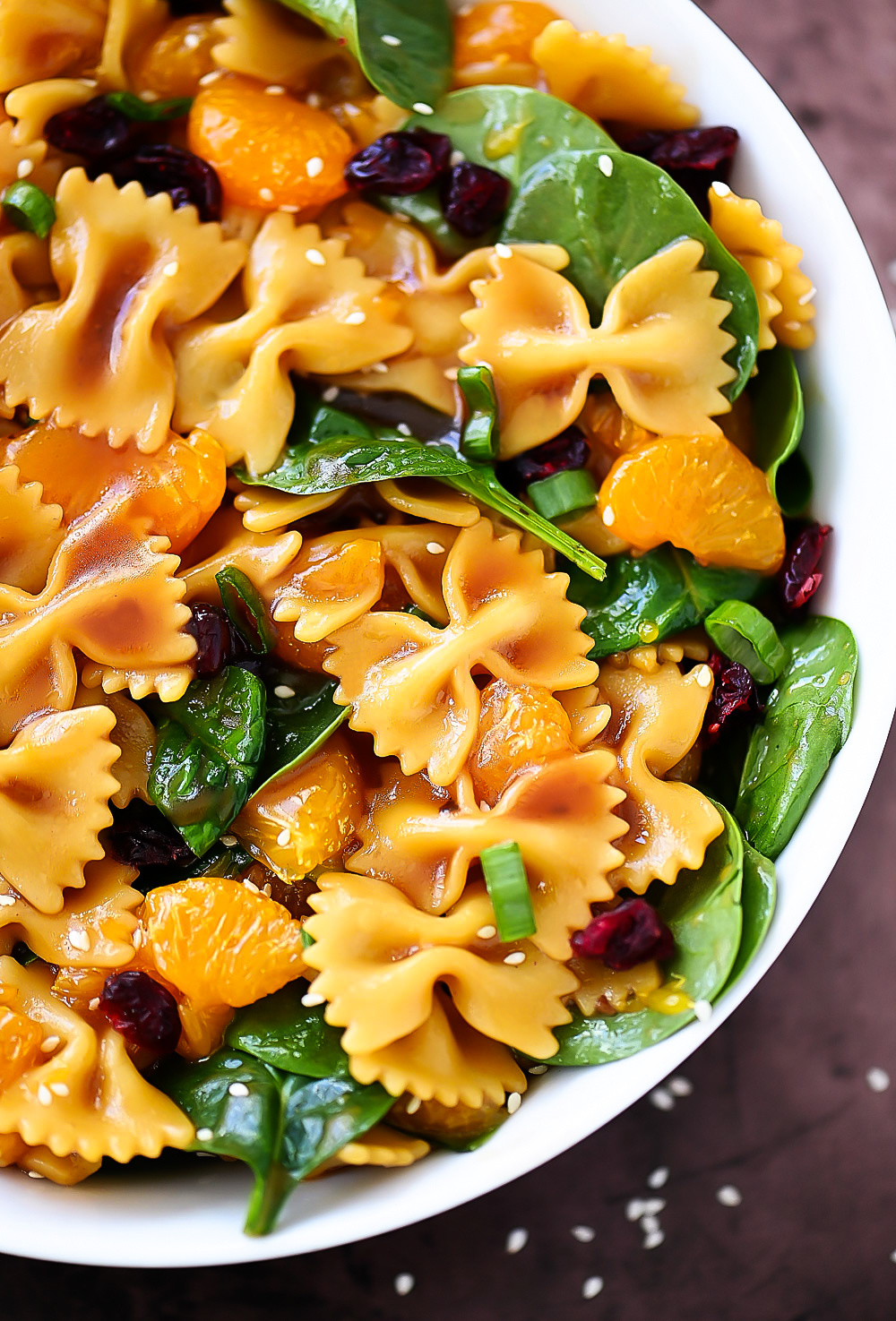 Mandarin Orange and Spinach Pasta Salad is bow tie pasta noodles coated in teriyaki sauce with oranges, spinach and dried cranberries. Life-in-the-Lofthouse.com