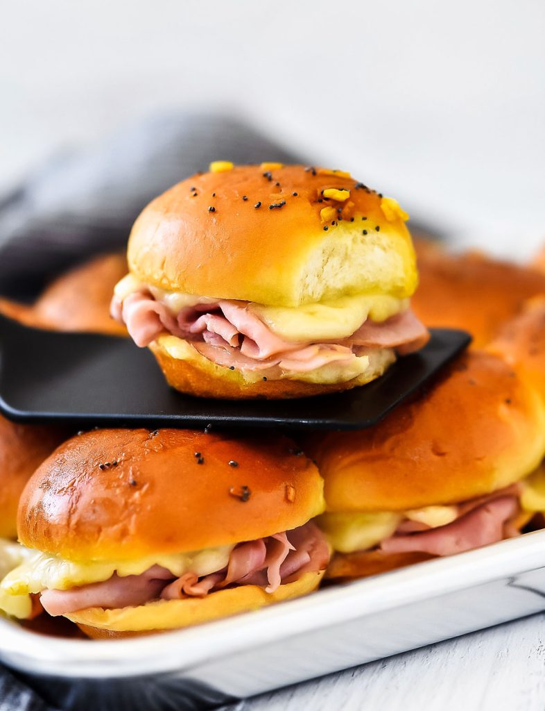 Ham and Cheese Sliders are savory and delicious baked ham sandwiches with a mustard poppy seed dressing. Life-in-the-Lofthouse.com