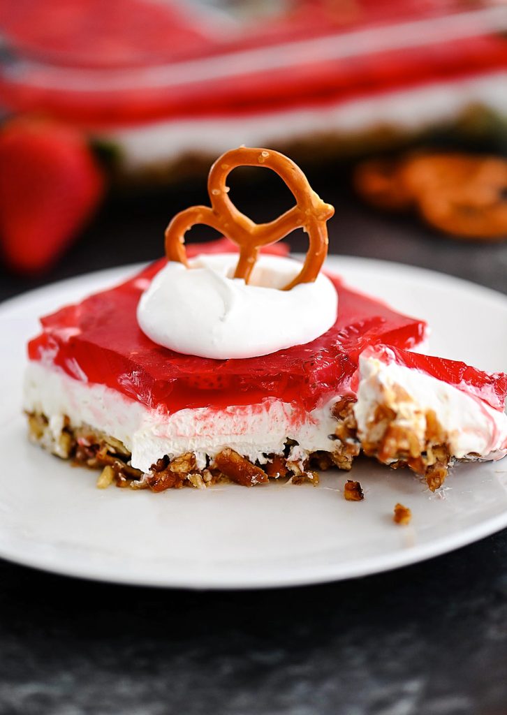 Pretzel salad with cream cheese filling and strawberries.