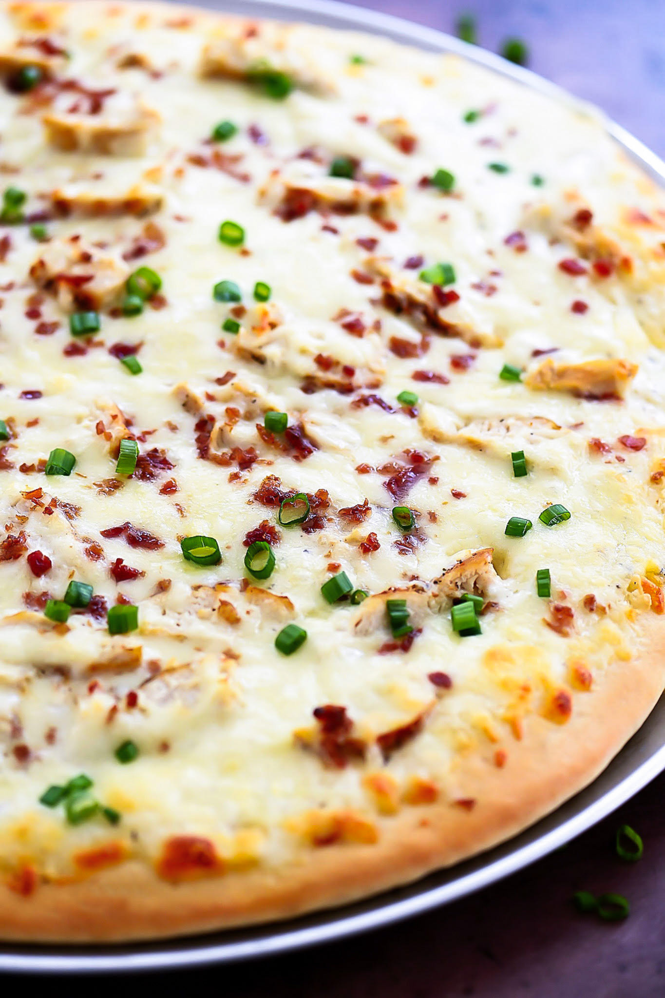 Alfredo Chicken Pizza is homemade pizza dough covered in Alfredo sauce and topped with chicken, bacon, garlic and cheese. Life-in-the-Lofthouse.com