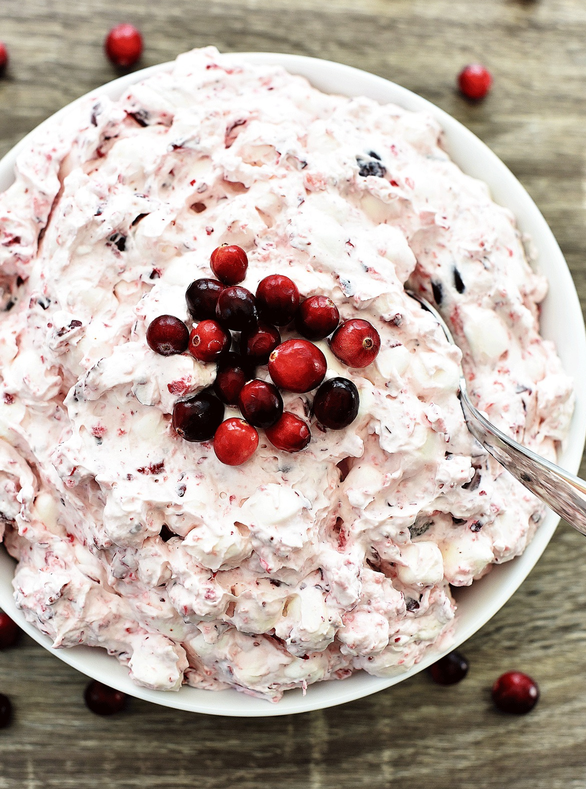 Cranberry Fluff is a creamy and sweet side dish filled with homemade whipped cream, cranberries, red grapes and marshmallows. Life-in-the-Lofthouse.com