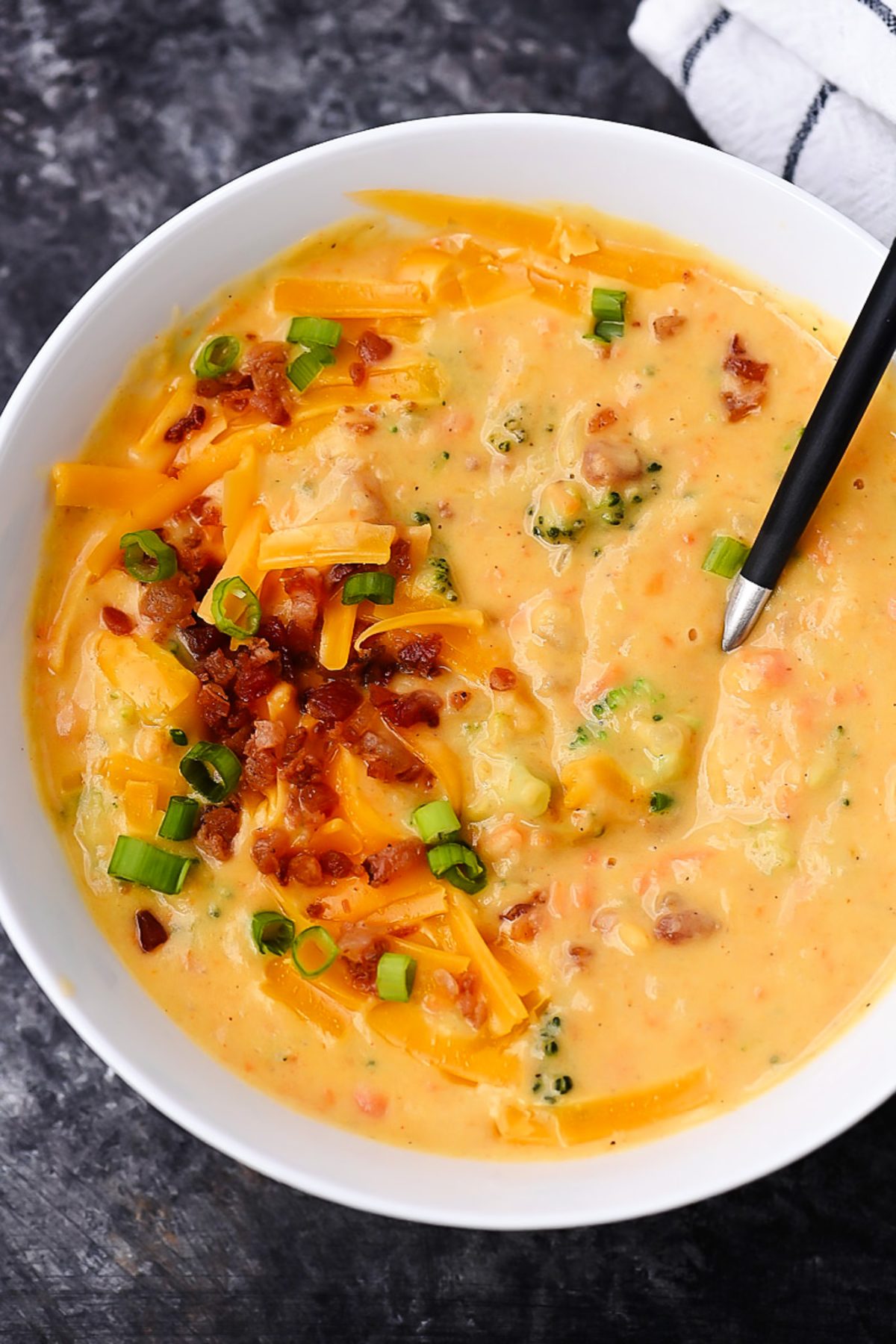 Creamy Slow Cooker Broccoli Cheese and Potato Soup with bacon and chive toppings